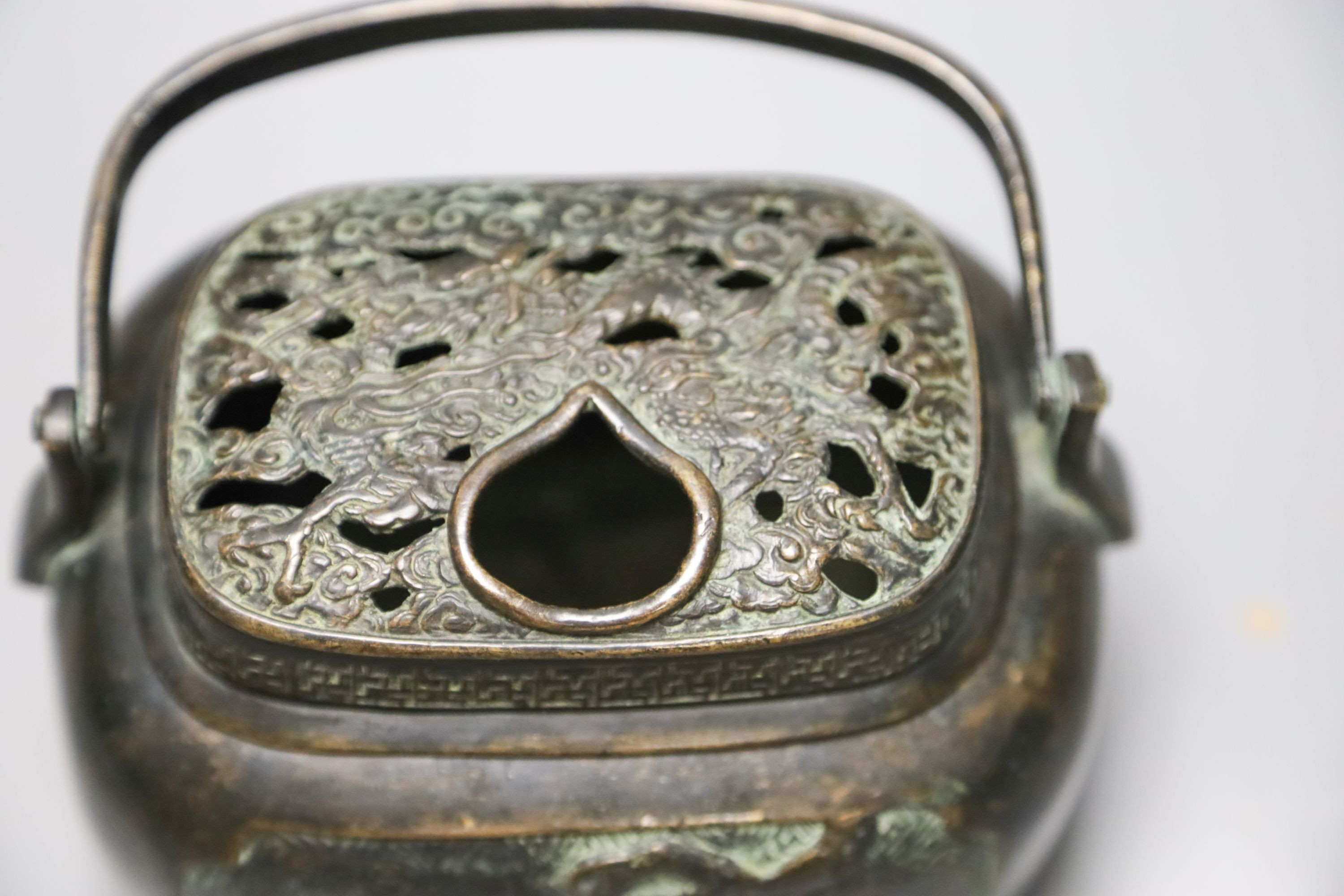 A Chinese bronze hand warmer, Xuande mark to base, old repairs 15cm